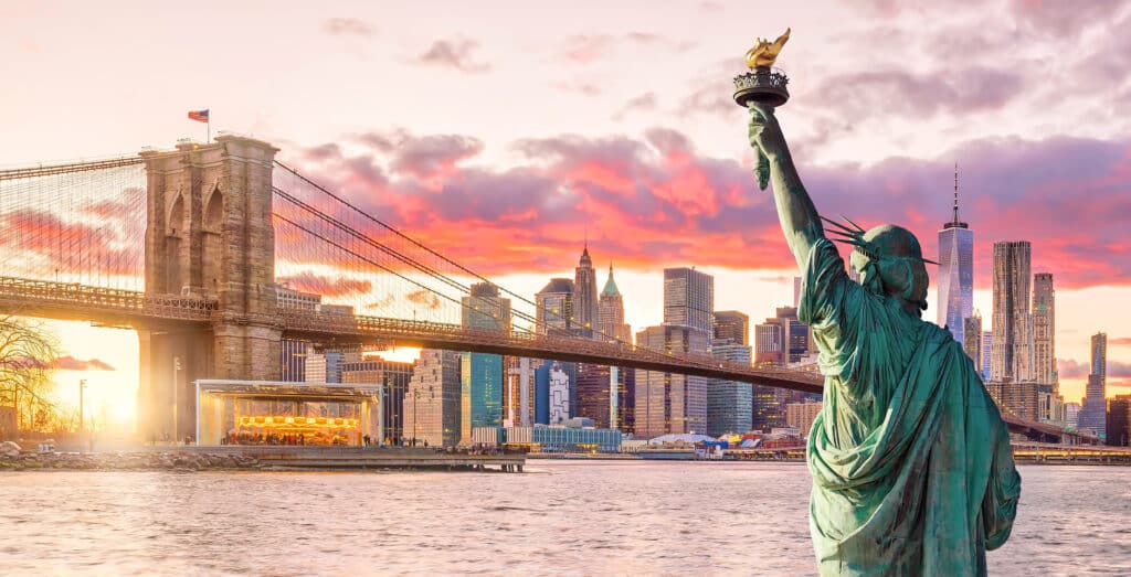 Statue Liberty and  New York city skyline at sunset,  in United States